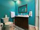 Stylish bathroom features a wood vanity with marble countertops and decorative, colorful walls at 9594 Doubloon Trl, Placida, FL 33946