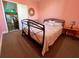 Bedroom with metal frame bed and view into a nearby kitchen at 9594 Doubloon Trl, Placida, FL 33946