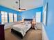 Comfortable bedroom with blue walls and plenty of natural light at 9594 Doubloon Trl, Placida, FL 33946