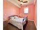 Bedroom featuring a metal bed frame, window, and ceiling fan at 9594 Doubloon Trl, Placida, FL 33946