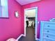 Pink bedroom with a peek into the closet with ample storage space at 9594 Doubloon Trl, Placida, FL 33946