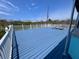 Large deck with white railing and views of vegetation and homes, perfect for enjoying the outdoors at 9594 Doubloon Trl, Placida, FL 33946