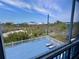 A serene outdoor deck featuring calming ocean views, lounge chairs, and bright blue planks at 9594 Doubloon Trl, Placida, FL 33946