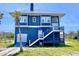Stunning two-story coastal home featuring a durable metal roof, charming blue siding, and elevated decks at 9594 Doubloon Trl, Placida, FL 33946