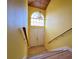 Bright foyer with wood-look floors, staircase, and a stylish chandelier for a welcoming entrance at 9594 Doubloon Trl, Placida, FL 33946