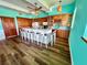 Well-lit kitchen with wooden cabinetry, a large center island with seating, and modern appliances at 9594 Doubloon Trl, Placida, FL 33946
