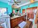 Kitchen island with sink, dishwasher, and wooden cabinets in an open-concept layout at 9594 Doubloon Trl, Placida, FL 33946