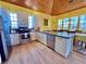 Modern kitchen featuring stainless steel appliances, white cabinetry, and adjacent dining area at 9594 Doubloon Trl, Placida, FL 33946