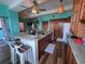 Open kitchen featuring a long island, bar stool seating, and warm wood cabinets at 9594 Doubloon Trl, Placida, FL 33946