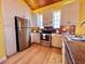 Bright kitchen with white cabinets, stainless steel appliances, and granite countertops at 9594 Doubloon Trl, Placida, FL 33946