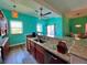 Kitchen island featuring a sink, wood cabinets, and a view to the dining area at 9594 Doubloon Trl, Placida, FL 33946