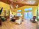 Bright living room featuring hardwood floors, high ceilings, and plenty of natural light at 9594 Doubloon Trl, Placida, FL 33946
