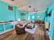 Aqua-themed living room featuring a cozy seating arrangement with a view of the dining area at 9594 Doubloon Trl, Placida, FL 33946