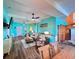 Expansive living area with laminate floors, a ceiling fan, and refreshing turquoise walls offer a comfortable atmosphere at 9594 Doubloon Trl, Placida, FL 33946