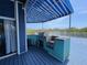 This outdoor kitchen features a built-in grill and covered space, perfect for entertaining and cooking outdoors at 9594 Doubloon Trl, Placida, FL 33946
