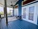 Blue painted porch features a ceiling fan, furniture, screen and view of neighborhood at 9594 Doubloon Trl, Placida, FL 33946