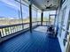 Blue painted porch features a ceiling fan, furniture, screen and view of neighborhood at 9594 Doubloon Trl, Placida, FL 33946
