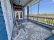 Blue painted porch features a ceiling fan, furniture, screen and view of neighborhood at 9594 Doubloon Trl, Placida, FL 33946