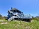 Inviting screened-in porch and an expansive white wooden deck perfect for outdoor entertaining and relaxation at 9594 Doubloon Trl, Placida, FL 33946
