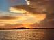 Scenic waterfront view featuring a stunning sunset with colorful sky and water reflection at 9594 Doubloon Trl, Placida, FL 33946