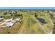 Aerial view of a single-story home situated on a golf course with mature trees and landscaping at 11 Oakland Hills Rd, Rotonda West, FL 33947