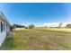 Backyard with a covered patio, showcasing outdoor living and green space at 11 Oakland Hills Rd, Rotonda West, FL 33947
