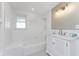 This is a bright bathroom with black and white tile and subway tile throughout at 11 Oakland Hills Rd, Rotonda West, FL 33947