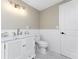 Bathroom with black and white tiled floor, classic fixtures, and neutral colored walls at 11 Oakland Hills Rd, Rotonda West, FL 33947