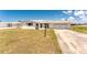 Single story home with an attached 2-car garage and a well-manicured lawn at 11 Oakland Hills Rd, Rotonda West, FL 33947
