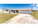 Charming single-story home with a driveway leading to an attached garage, plus well-maintained front yard at 11 Oakland Hills Rd, Rotonda West, FL 33947