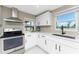 Modern kitchen featuring stainless steel appliances, plenty of white cabinets, and natural light at 11 Oakland Hills Rd, Rotonda West, FL 33947