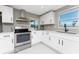 Modern kitchen with stainless steel appliances, white cabinets, and plenty of natural light at 11 Oakland Hills Rd, Rotonda West, FL 33947