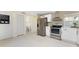 Bright kitchen featuring stainless steel appliances and ample white cabinetry at 11 Oakland Hills Rd, Rotonda West, FL 33947