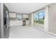Bright kitchen with stainless steel appliances, white cabinets, and a view to the outside at 11 Oakland Hills Rd, Rotonda West, FL 33947
