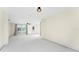Bright living room with ceiling fan, and large sliding glass doors and a front door at 11 Oakland Hills Rd, Rotonda West, FL 33947