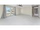 Bright living room with ceiling fan, and large sliding glass doors to exterior at 11 Oakland Hills Rd, Rotonda West, FL 33947