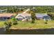 A well maintained lawn on this canal front home with a screened pool at 1157 Rotonda Cir, Rotonda West, FL 33947