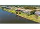 Back of house features a screened in lanai and backyard with canal at 1157 Rotonda Cir, Rotonda West, FL 33947