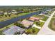 Waterfront home with lush landscaping, spacious driveway, and a serene canal view at 1157 Rotonda Cir, Rotonda West, FL 33947