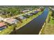 Waterfront home featuring a screened pool, lush landscaping, and canal access at 1157 Rotonda Cir, Rotonda West, FL 33947