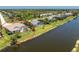Canal front home featuring a screened pool and well maintained lawn at 1157 Rotonda Cir, Rotonda West, FL 33947