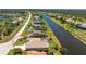 Birds eye view of a waterfront single-Gathering home and surrounding community at 1157 Rotonda Cir, Rotonda West, FL 33947