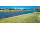 A pristine lake sits behind a manicured green lawn at 1157 Rotonda Cir, Rotonda West, FL 33947