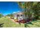 Landscaped backyard featuring a screened-in lanai and lush greenery, creating a private retreat at 1157 Rotonda Cir, Rotonda West, FL 33947