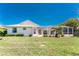 A charming home featuring a backyard with a screened-in lanai and pool area, plus lush green lawn at 1157 Rotonda Cir, Rotonda West, FL 33947