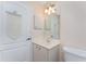 Bathroom featuring a single vanity with storage and a decorative lighthouse themed wall-hanging at 1157 Rotonda Cir, Rotonda West, FL 33947