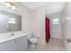 Bathroom with a white vanity, a toilet, and a shower behind a red curtain at 1157 Rotonda Cir, Rotonda West, FL 33947