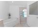 Bright bathroom with a soaking tub, walk-in shower, and a decorative arched window at 1157 Rotonda Cir, Rotonda West, FL 33947