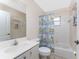 Bathroom featuring a single vanity, commode, and shower/tub combination with nautical themed shower curtain at 1157 Rotonda Cir, Rotonda West, FL 33947