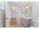 Bathroom with a white vanity and an open door that leads to a bedroom at 1157 Rotonda Cir, Rotonda West, FL 33947